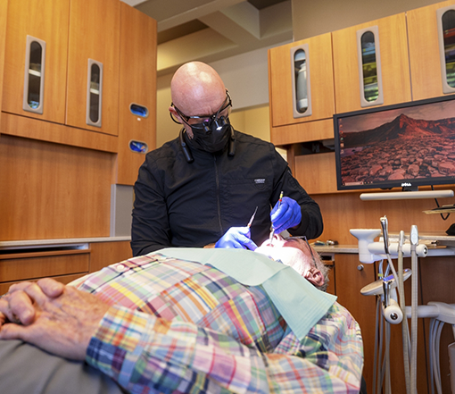 Forest Grove dentist examining a patient's mouth