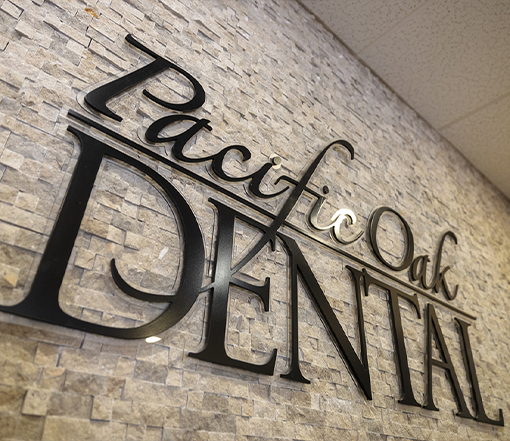 Pacific Oak Dental sign on the wall of a dental office in Forest Grove